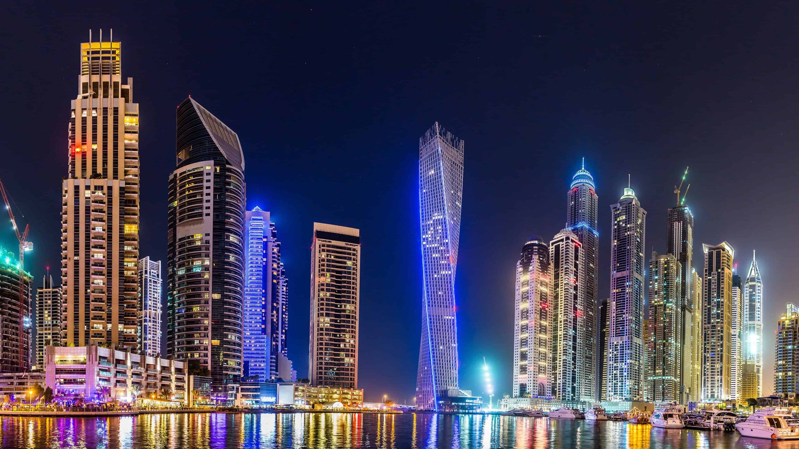 Dubai skyline at night, illuminated skyscrapers along the marina